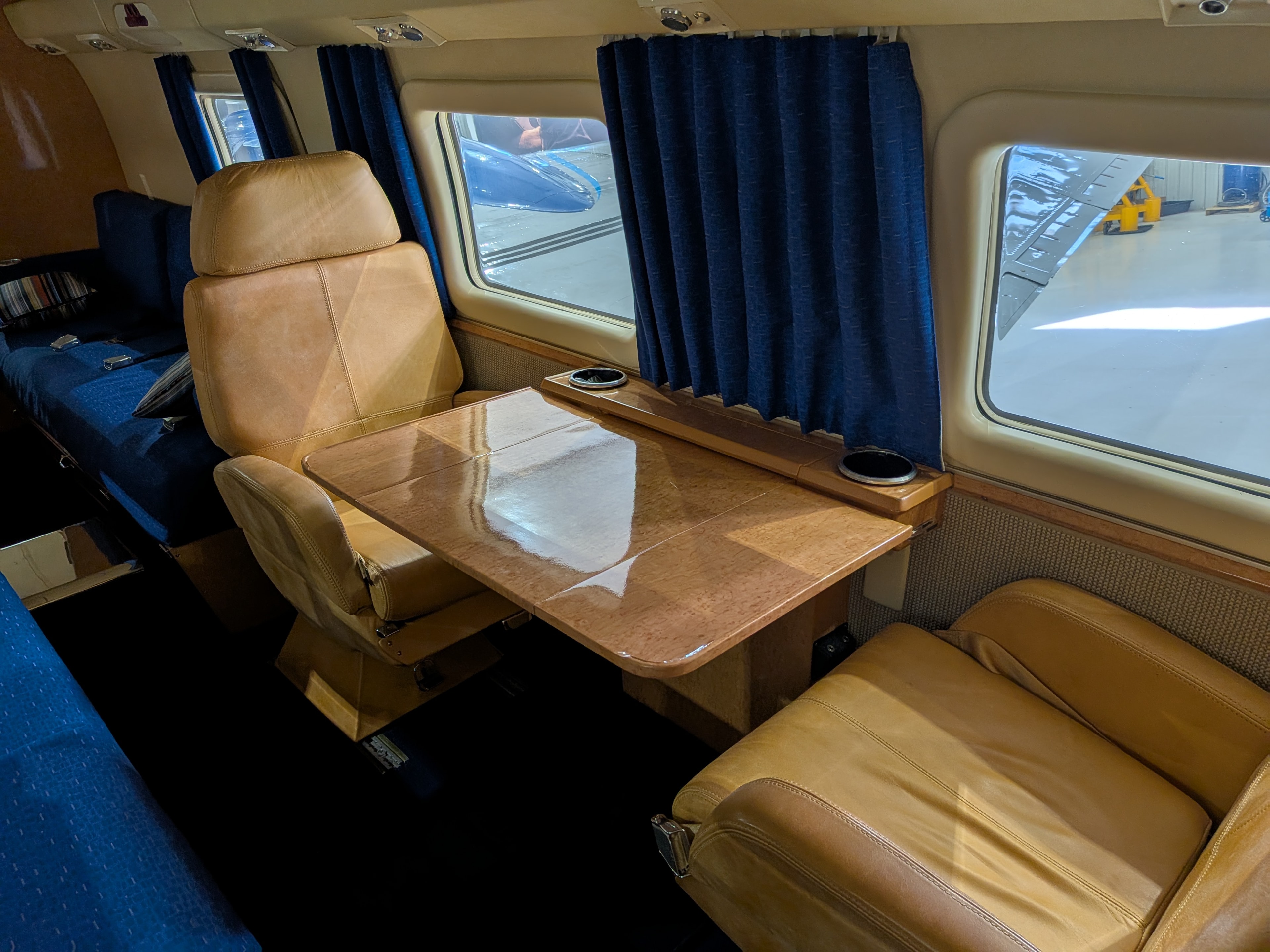 Howard 500 cabin — tan leather seats and wood table