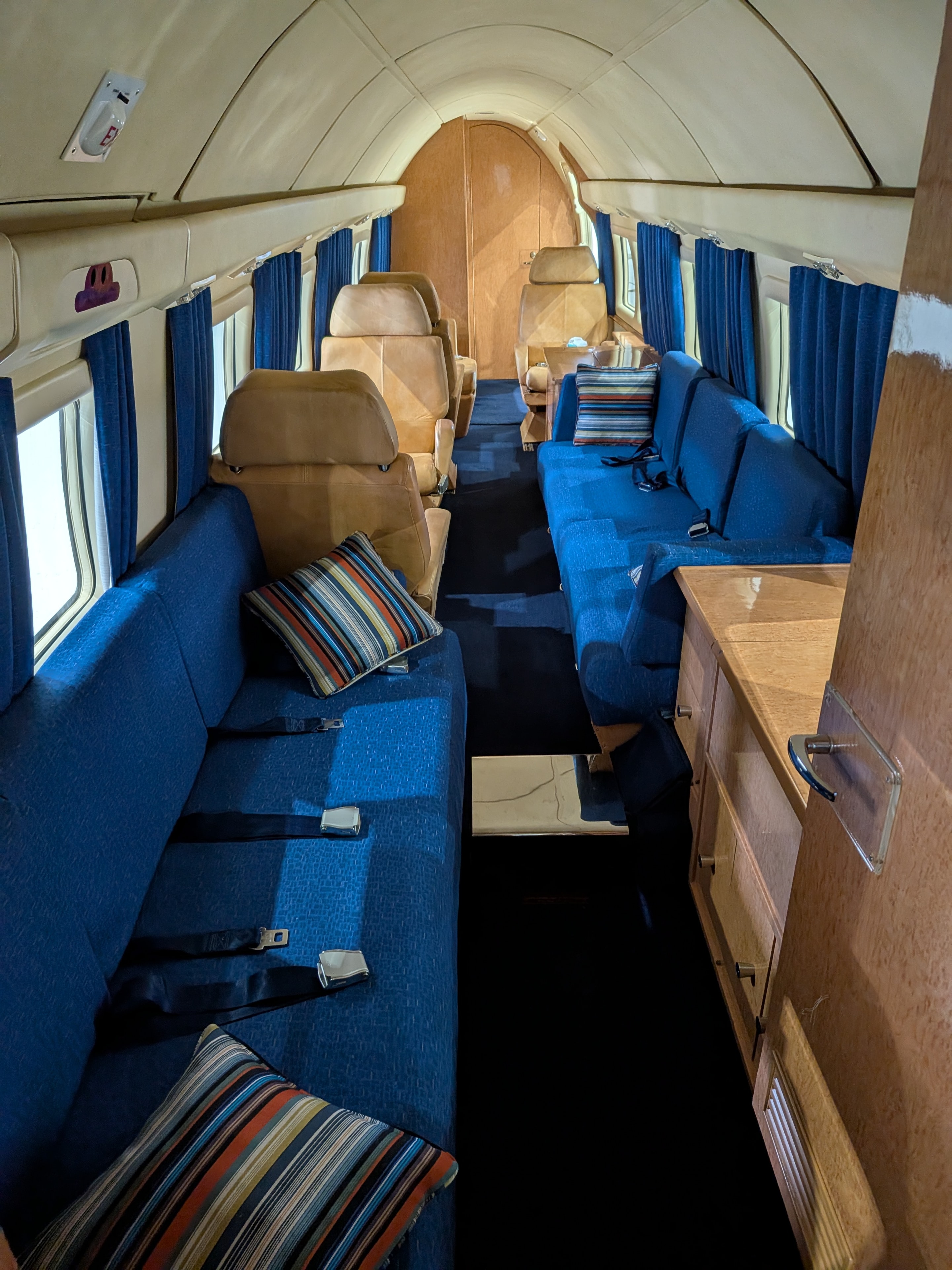 Howard 500 full cabin looking forward — blue seating and leather chairs